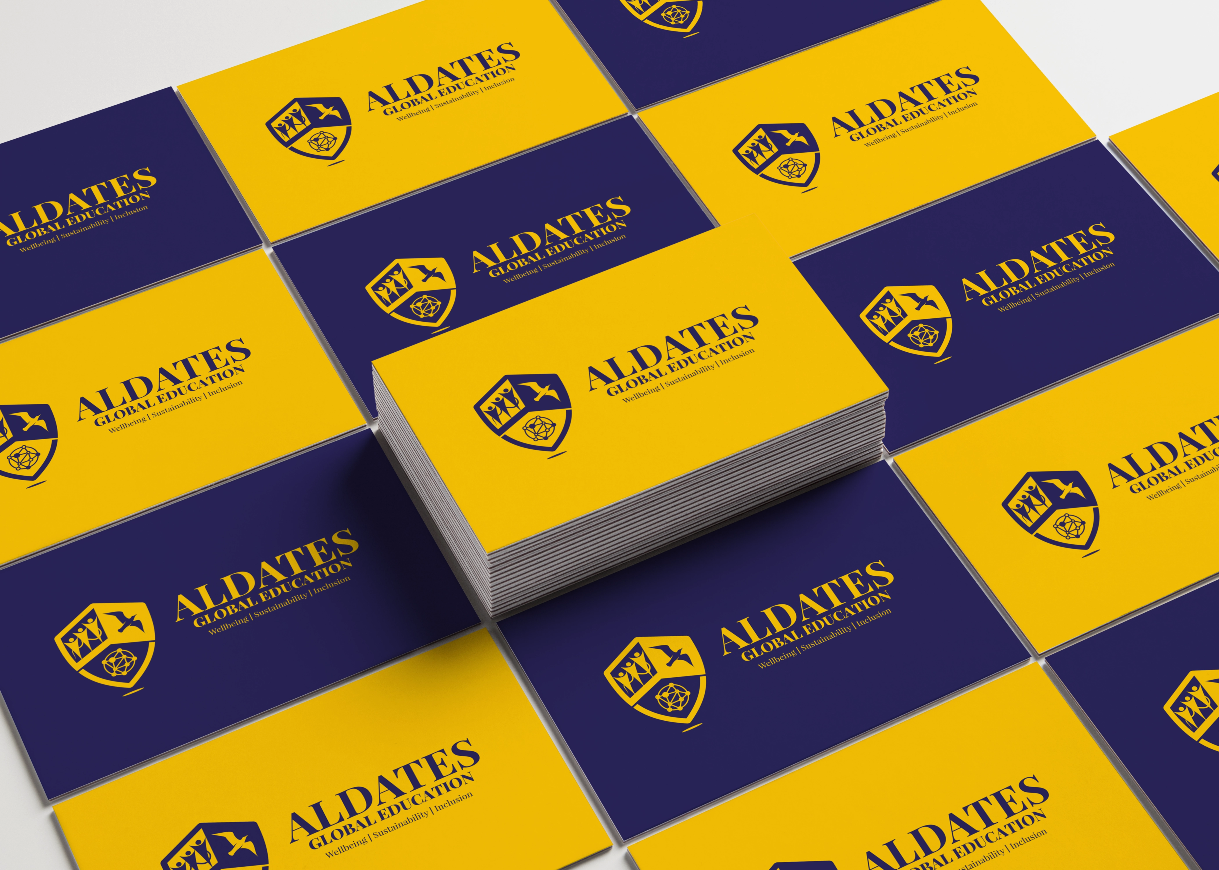 Aldates Global Education business cards, navy blue and yellow with the shield logo
