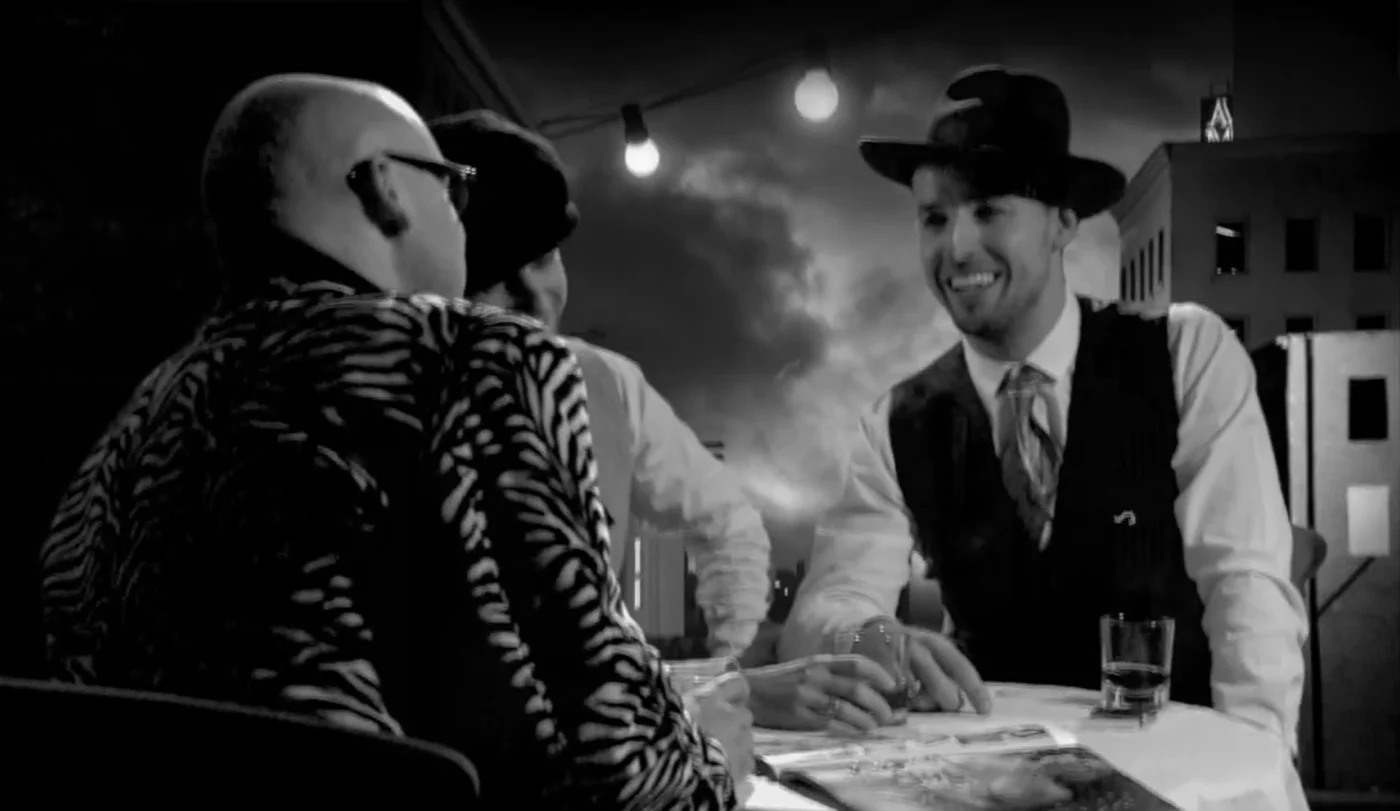 Swingers film still of two performers in the miniature-city setting